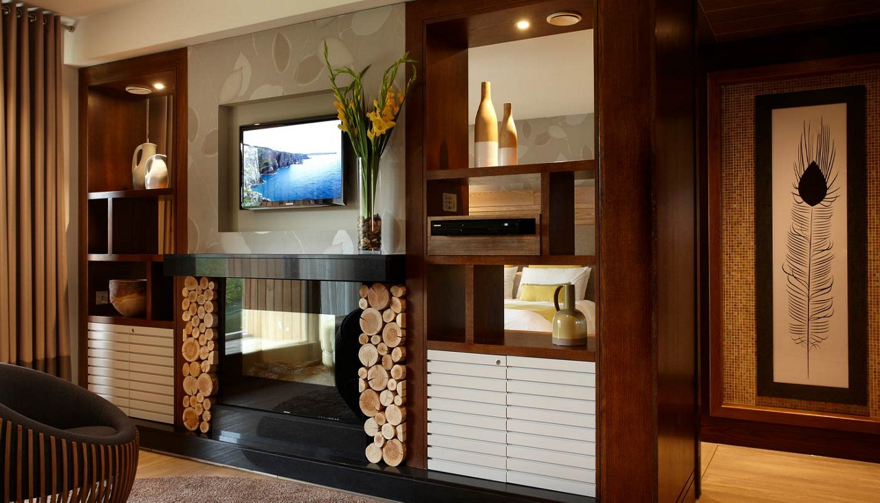 Lounge area with a mounted TV and built in fireplace.