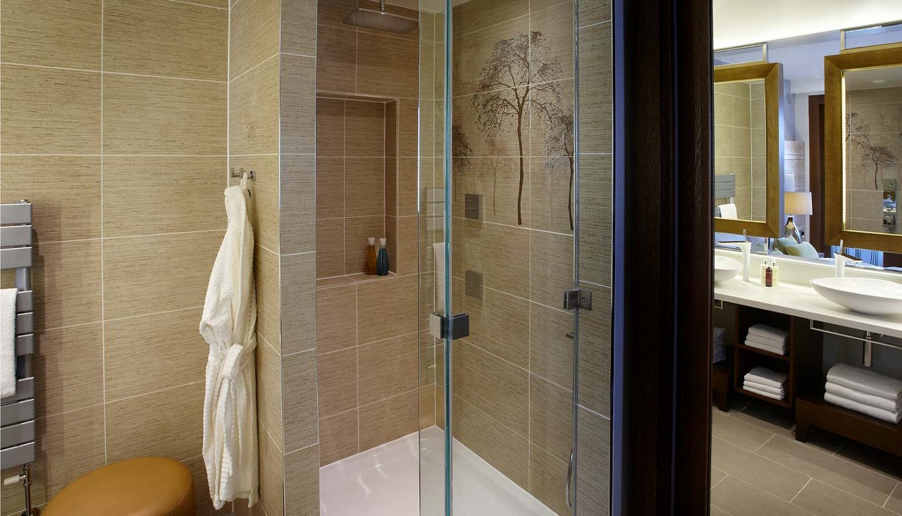 En suite shower with soft robes.