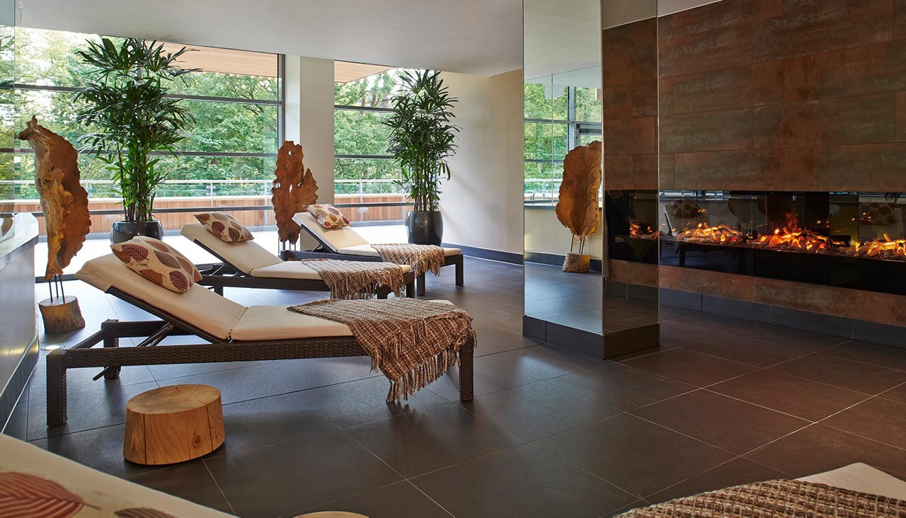 Relax area with open fire and lounge seating.