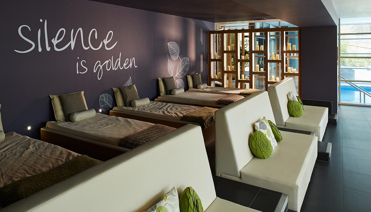 Waterbeds in a room lit with glowing candles.