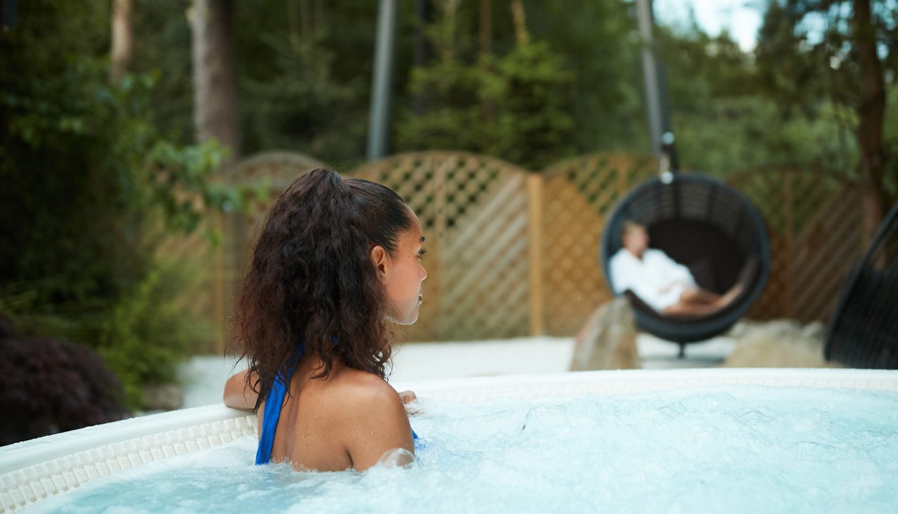 Woman sitting in a bubbling hot tub