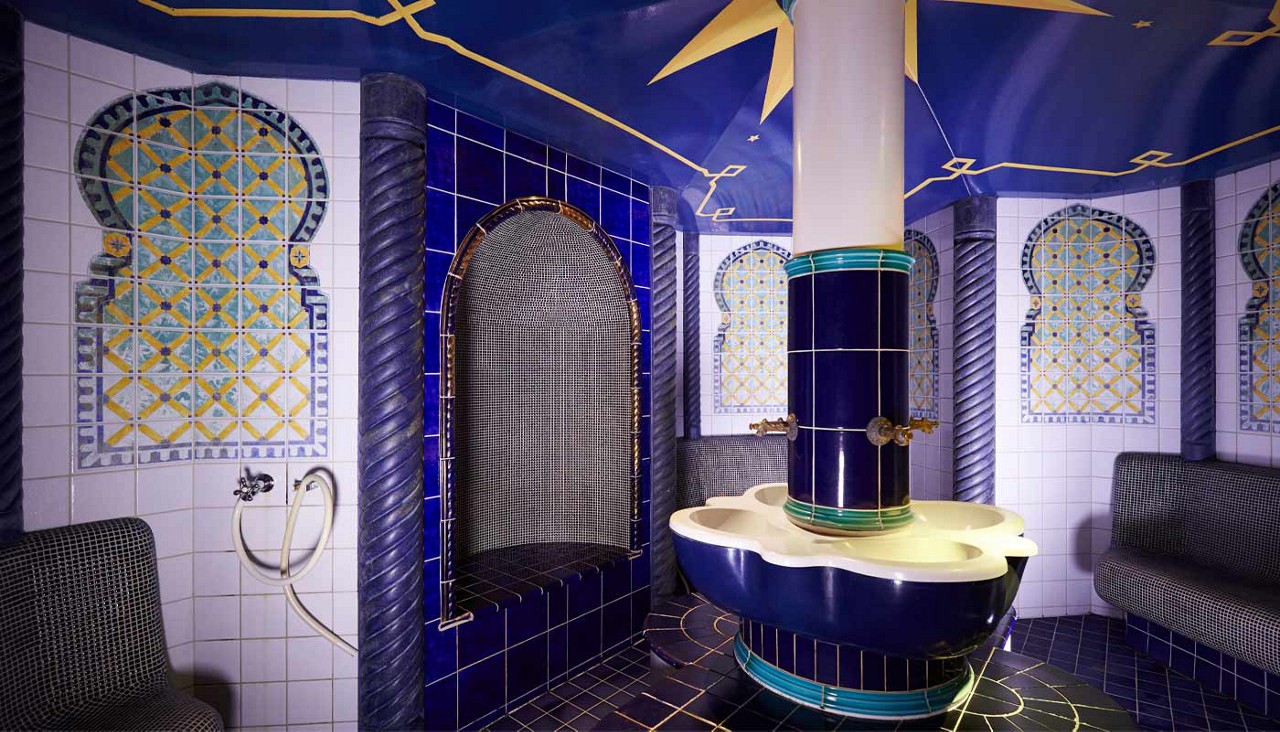 Decorative tiled room with artwork on the walls.