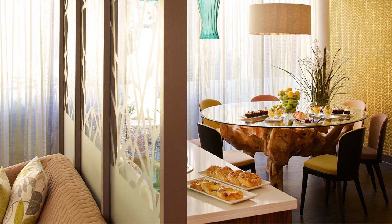 Inside The Hideaway with a large round table with delicious treats displayed.