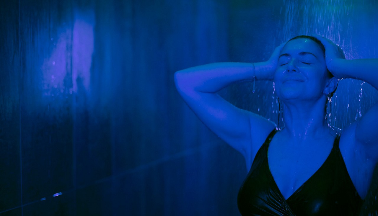 Woman soaking under a Rain Walk shower