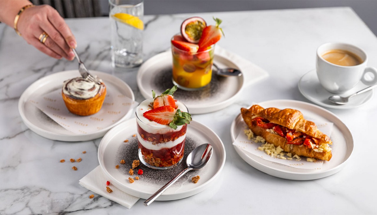 A selection of breakfast items including granola and fruit salad.