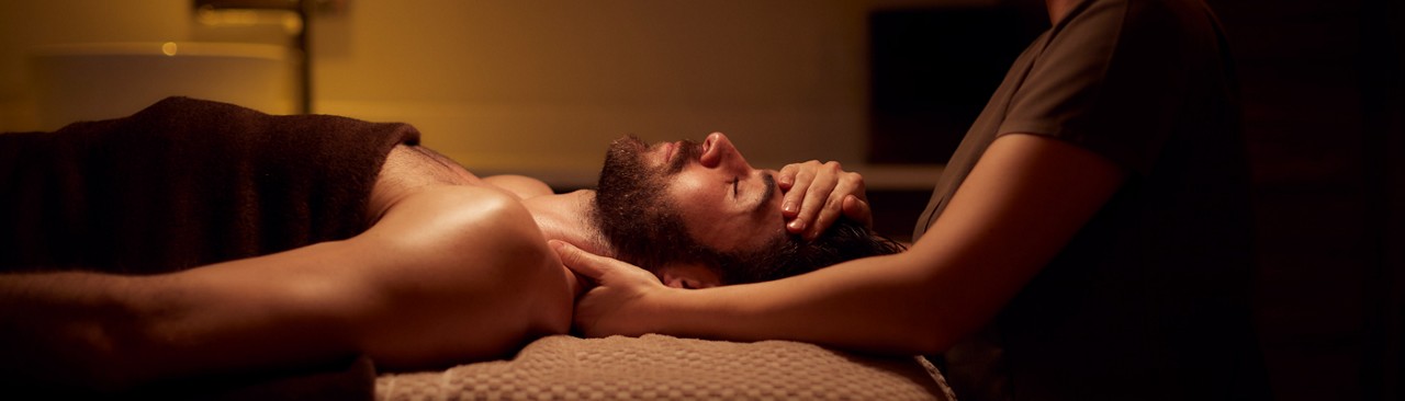 man laid in towel receiving treatment 