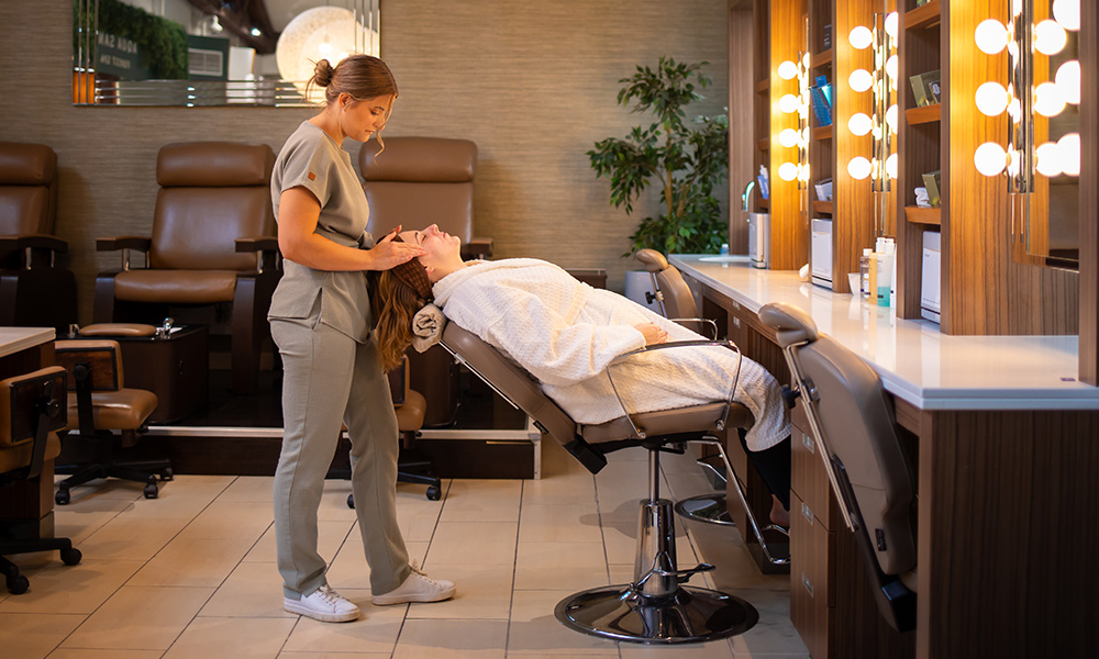 Woman laying back in the express treatment area having a facial.