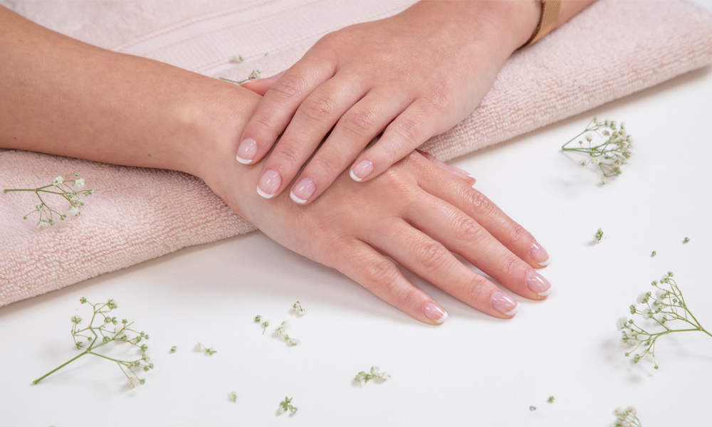 Two hands showing beautifully painted nails.