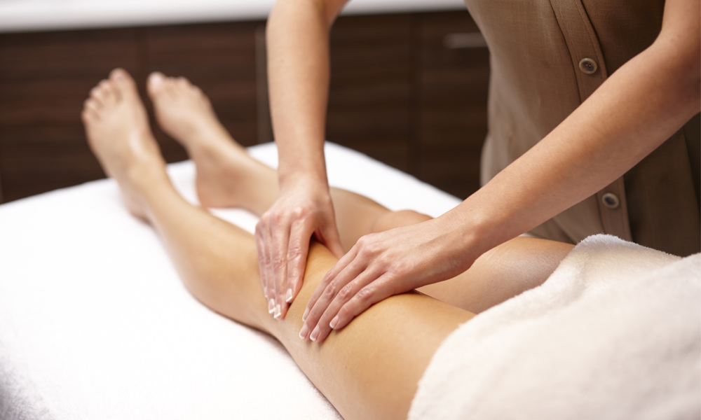 women receiving body massage on the leg