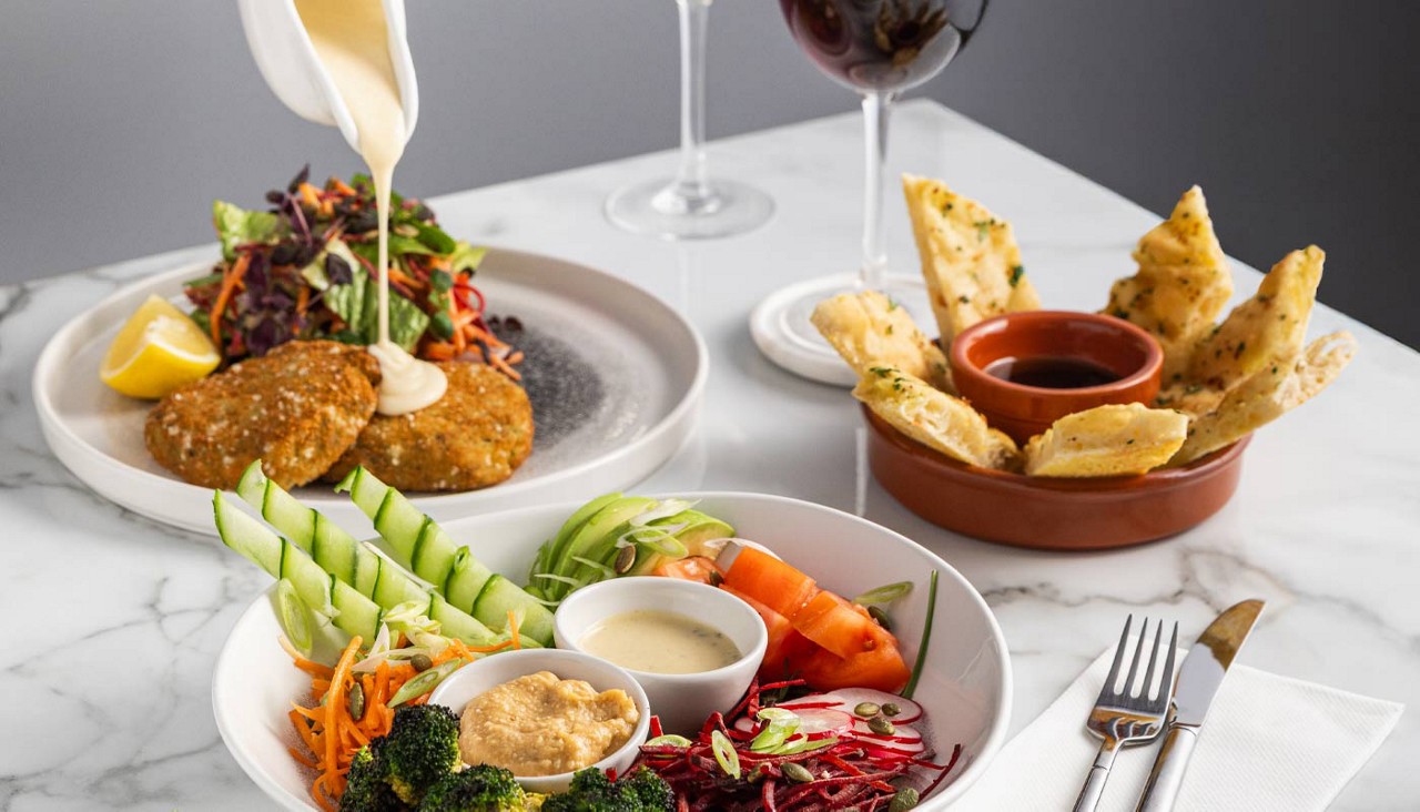A selection of fishcakes and salads.