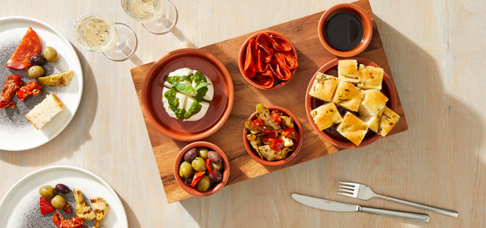 Sharing platter with dips and flaatbreads.